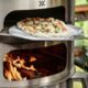Breeo Pizza Oven and man cooking